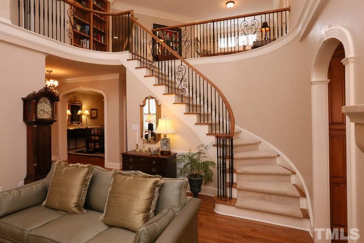 1837 Torrington Street Raleigh, NC 27615 - Photo 13 of 25 Elegant curved stairs echo the doorways throughout the formal rooms.