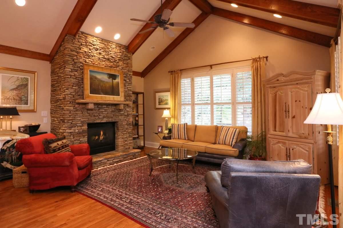 1837 Torrington Street Raleigh, NC 27615 - Photo 8 of 25 Stacked stone gas log fireplace, beamed vaulted ceiling, recessed lighting
