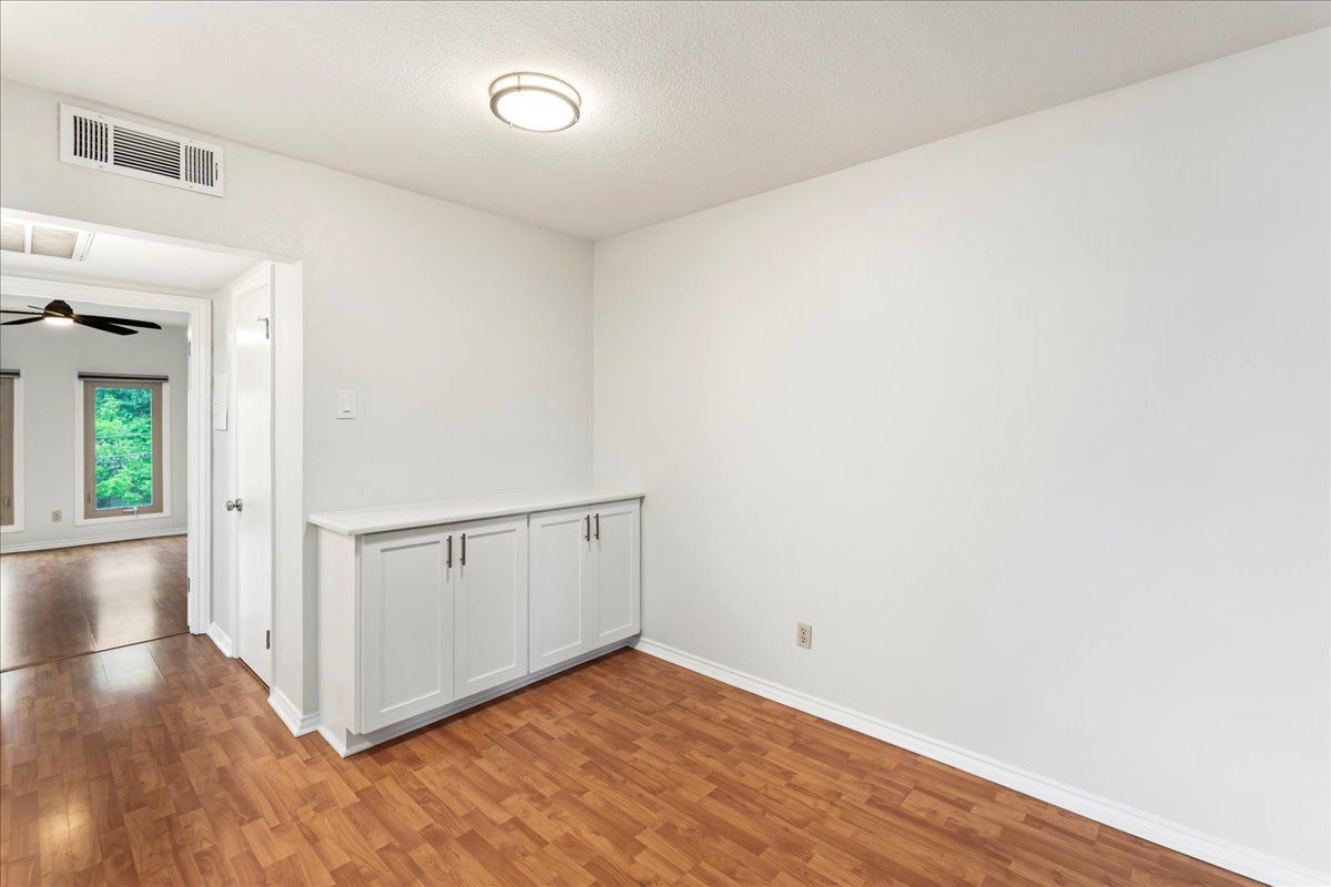 505 West 7th Street, Unit 313 Austin, TX 78701 - Photo 11 of 30 Spare room with baseboards, a ceiling fan, visible vents, and light wood-style floors