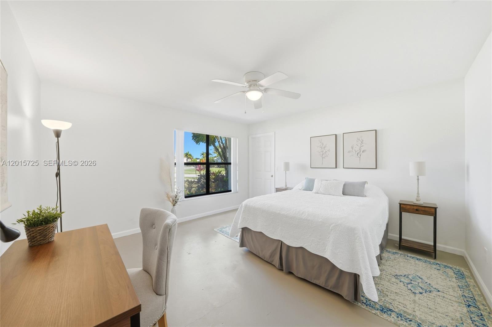 11008 Boca Woods Lane Boca Raton, FL 33428 - Photo 20 of 70 a bedroom with a bed chandelier and a window