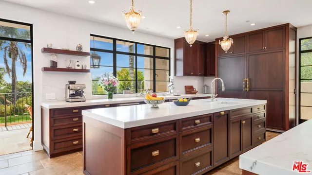 a kitchen with a sink a counter and chairs