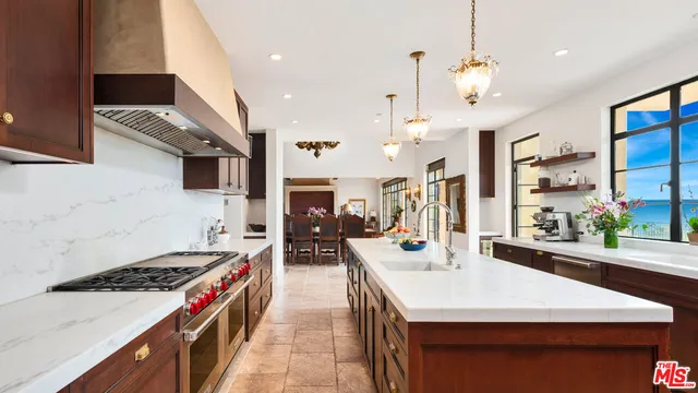 a kitchen with stove and refrigerator