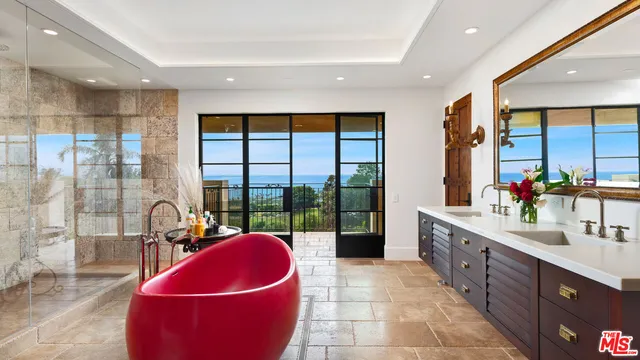 a kitchen with granite countertop a sink and dishwasher a flat screen tv