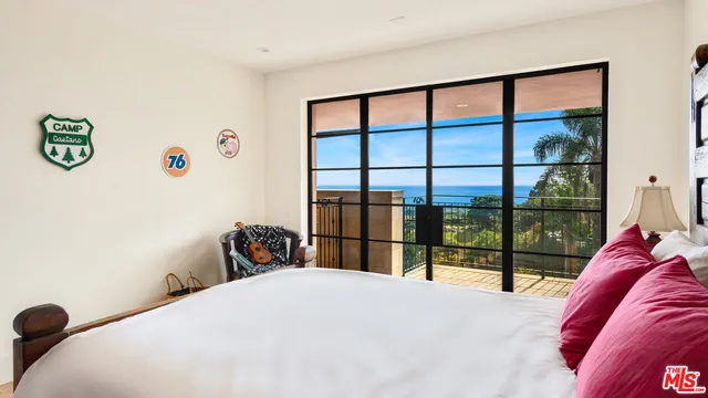a bedroom with a bed and a large window