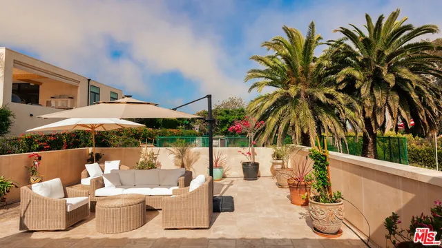 a view of a patio with couches and potted plants