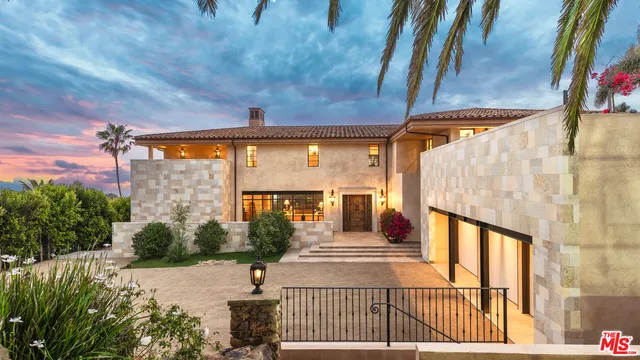 a view of a porch with a table and chairs