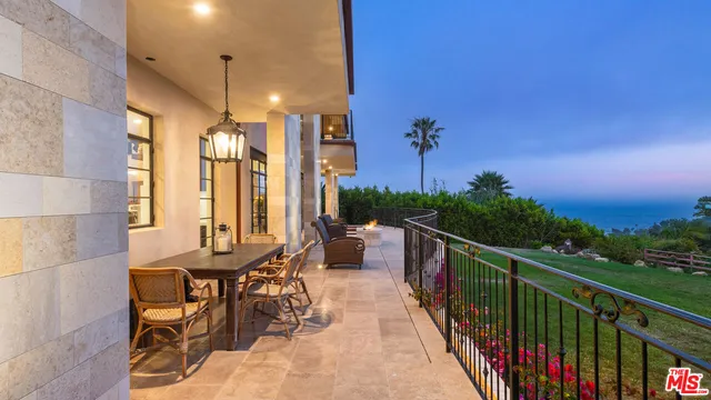 a view of balcony with chairs and wooden fence