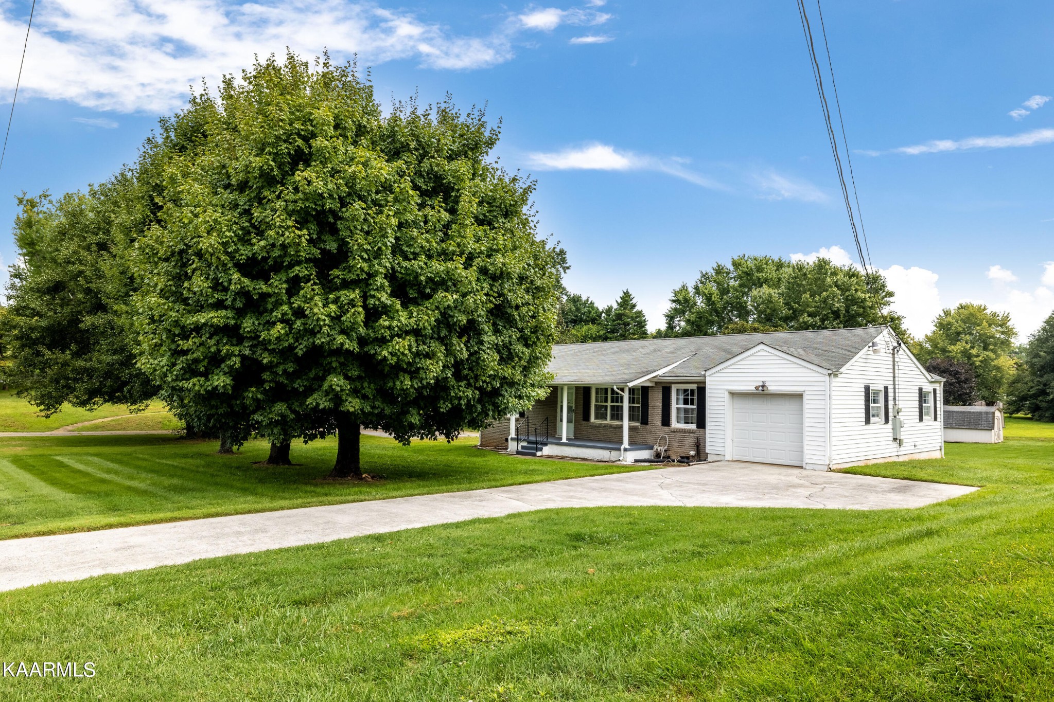 7612 Gill Road Powell, TN 37849 - Photo 14 of 14 a front view of a house with a yard table and chairs