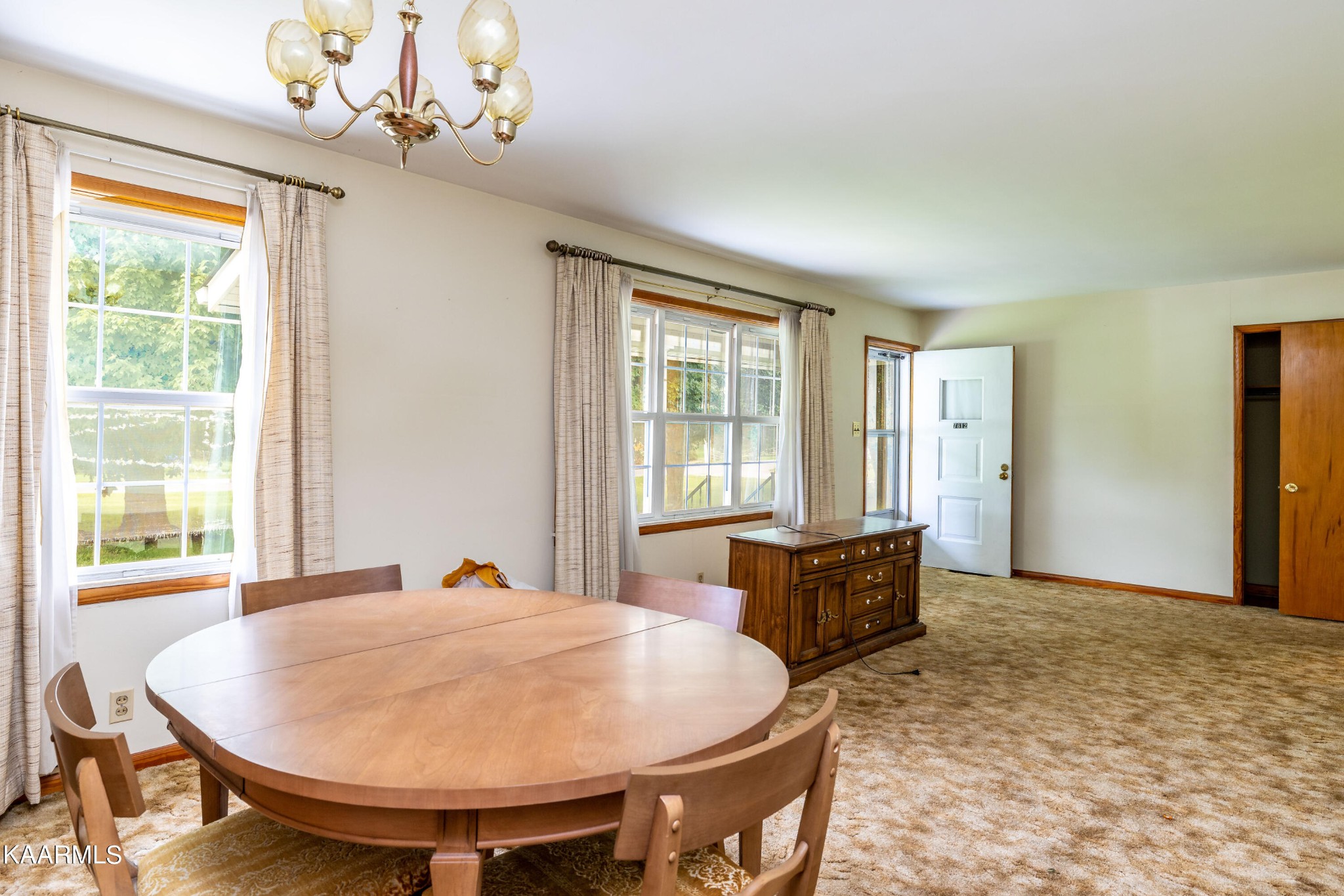 7612 Gill Road Powell, TN 37849 - Photo 3 of 14 a view of a dining room with furniture window and wooden floor