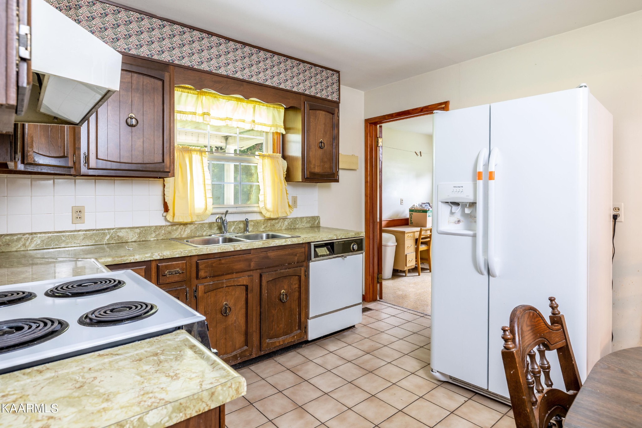 7612 Gill Road Powell, TN 37849 - Photo 5 of 14 a kitchen with stainless steel appliances granite countertop a stove a sink and a refrigerator