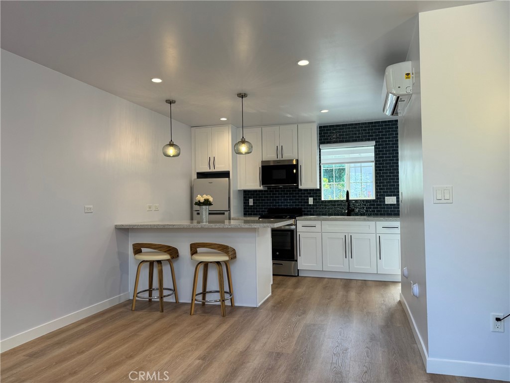 827 Delaware Road, Unit ADU Burbank, CA 91504 - Photo 4 of 20 a kitchen with white cabinets and appliances