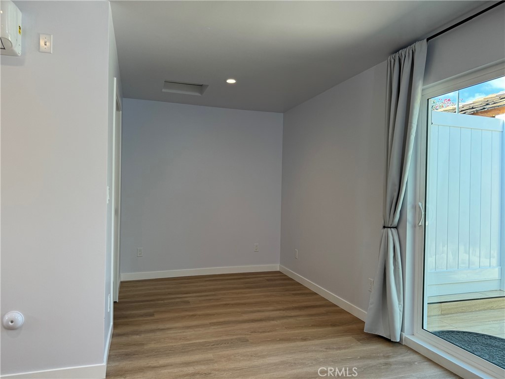 827 Delaware Road, Unit ADU Burbank, CA 91504 - Photo 9 of 20 a view of an empty room with wooden floor and a window