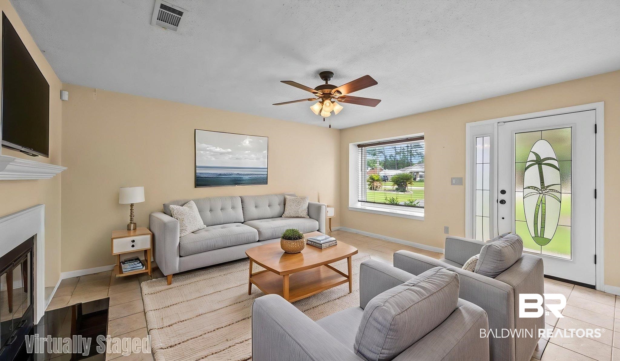 15096 Highland Circle Foley, AL 36535 - Photo 10 of 52 Living area featuring neutral wall tones, tile flooring, a fireplace with a white mantel, and a ceiling fan with integrated lighting