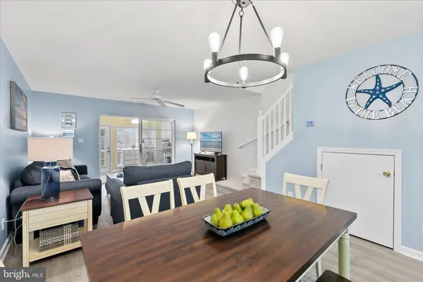 a living room with a table chairs and a table
