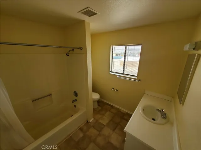 a kitchen with wooden floors and white walls