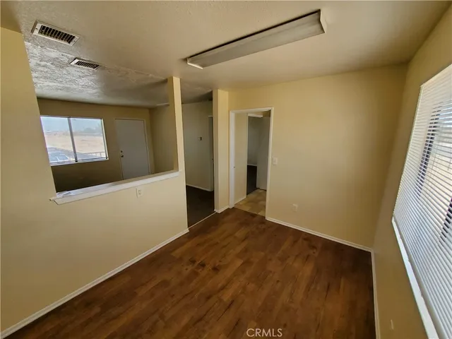 a view of an empty room and a window