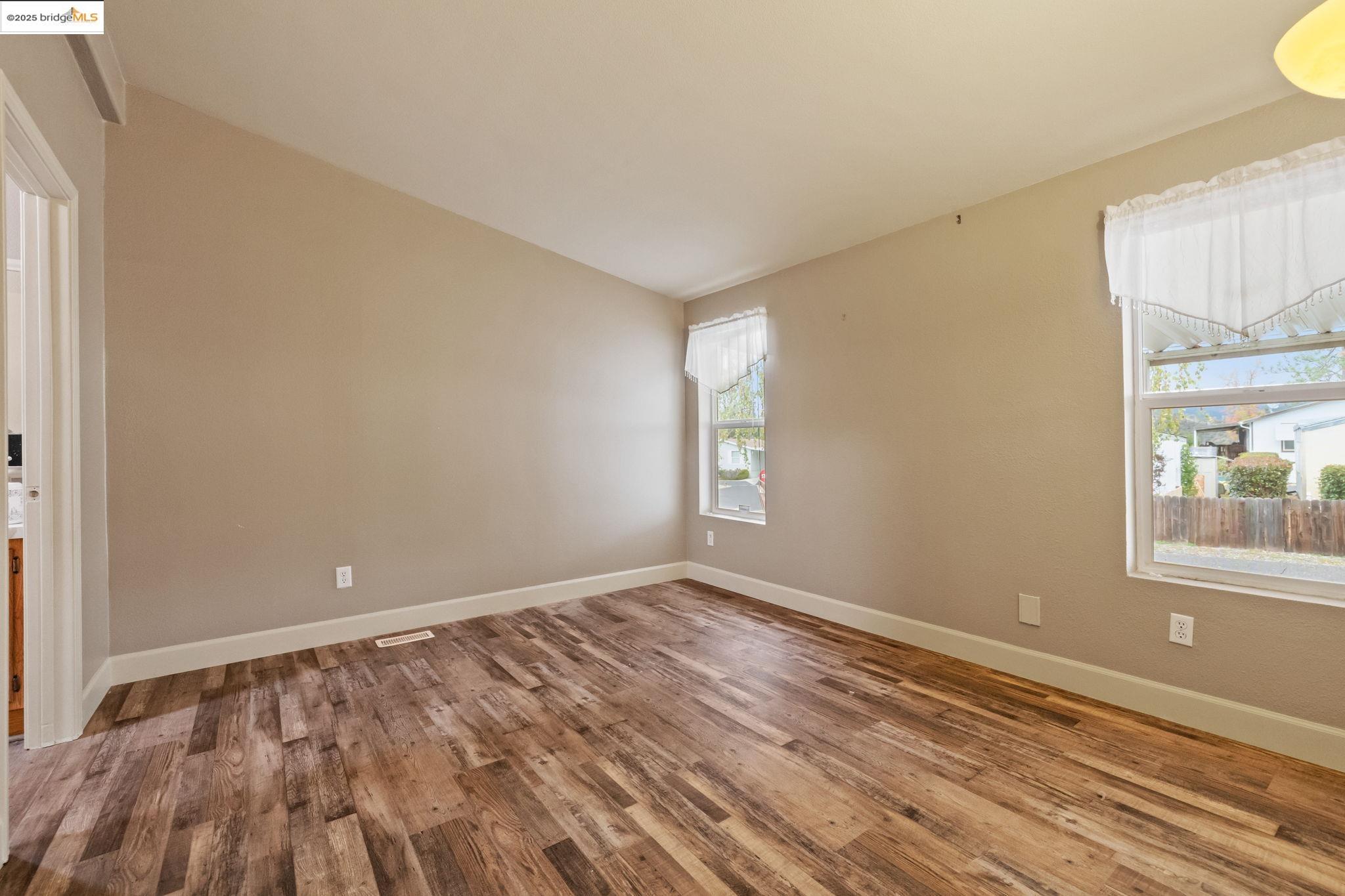 18717 Mill Villa Road, Unit 610 Jamestown, CA 95327 - Photo 17 of 35 a view of empty room with wooden floor and fan
