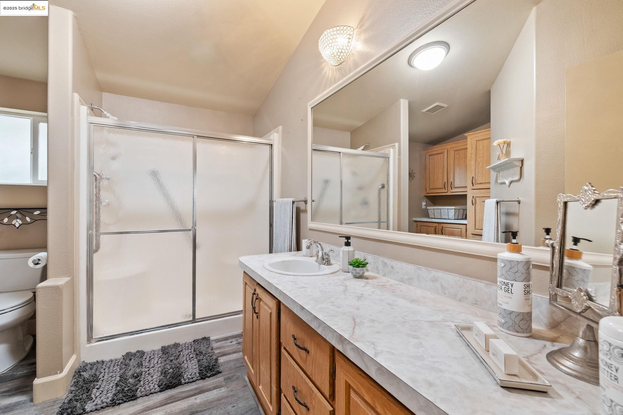 18717 Mill Villa Road, Unit 610 Jamestown, CA 95327 - Photo 18 of 35 a spacious bathroom with a granite countertop sink and a mirror
