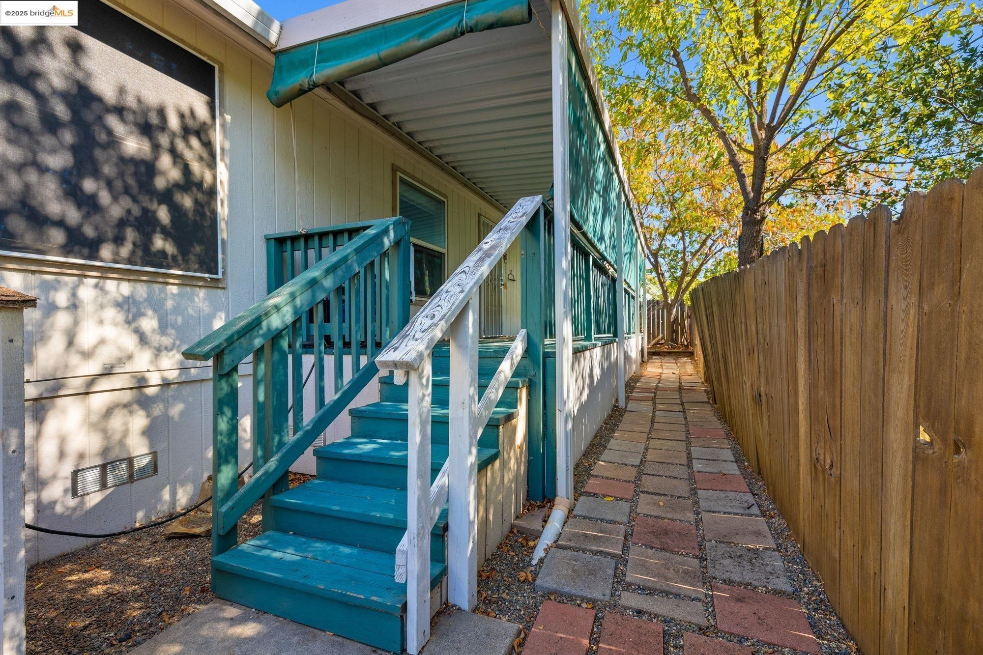 18717 Mill Villa Road, Unit 610 Jamestown, CA 95327 - Photo 23 of 35 a view of staircase with wooden floor and fence