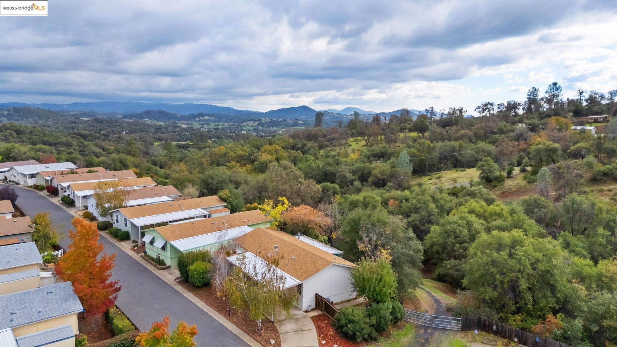 18717 Mill Villa Road, Unit 610 Jamestown, CA 95327 - Photo 28 of 35 an aerial view of a city with lots of residential buildings ocean and mountain view in back