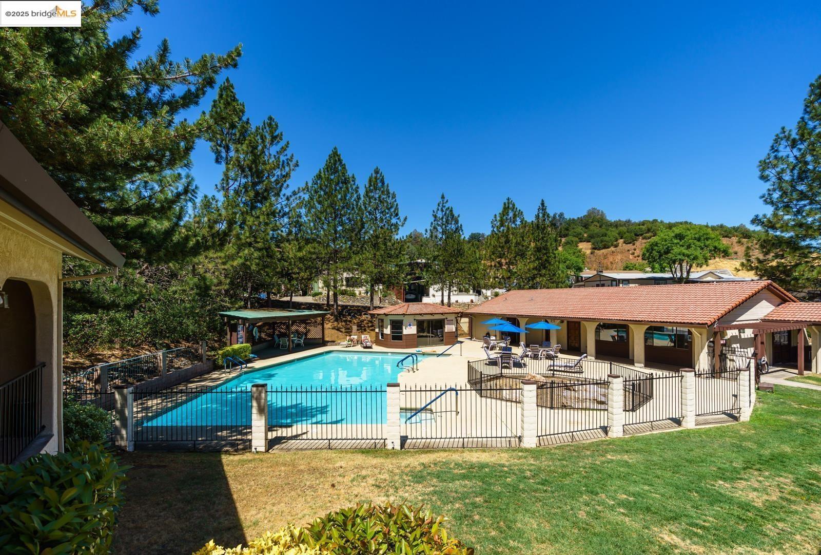 18717 Mill Villa Road, Unit 610 Jamestown, CA 95327 - Photo 32 of 35 a swimming pool with outdoor seating and yard