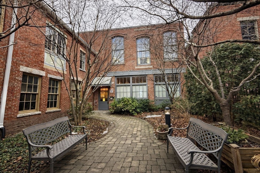 30 Market Street, Unit 7 Lowell, MA 01852 - Photo 11 of 11 a view of a brick house with many windows