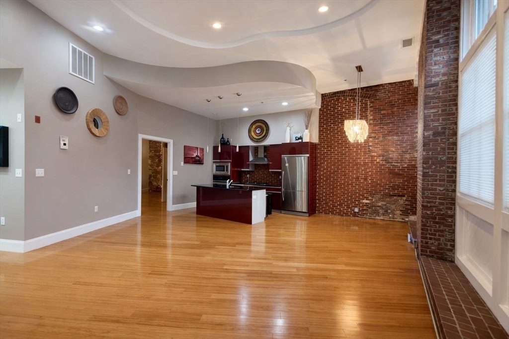 30 Market Street, Unit 7 Lowell, MA 01852 - Photo 2 of 11 a large kitchen with stainless steel appliances granite countertop a sink and a stove