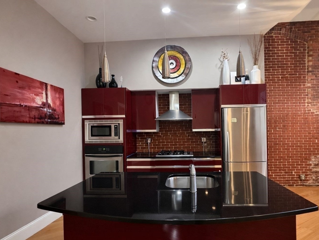 30 Market Street, Unit 7 Lowell, MA 01852 - Photo 4 of 11 a kitchen with a stove and a microwave