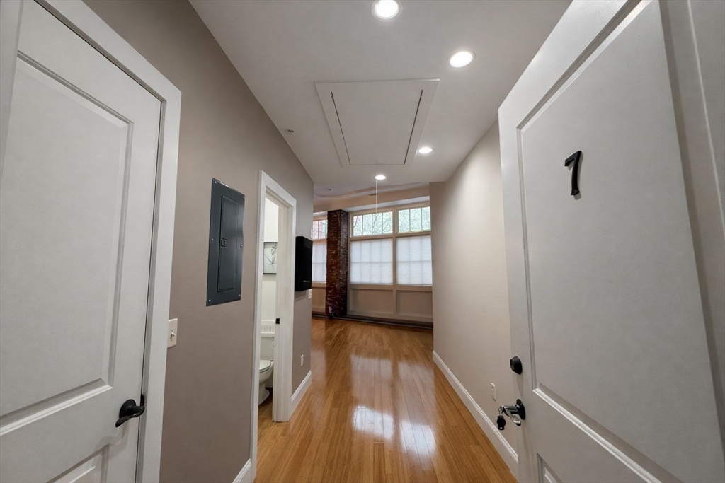 30 Market Street, Unit 7 Lowell, MA 01852 - Photo 7 of 11 a view of a hallway with wooden floor and staircase
