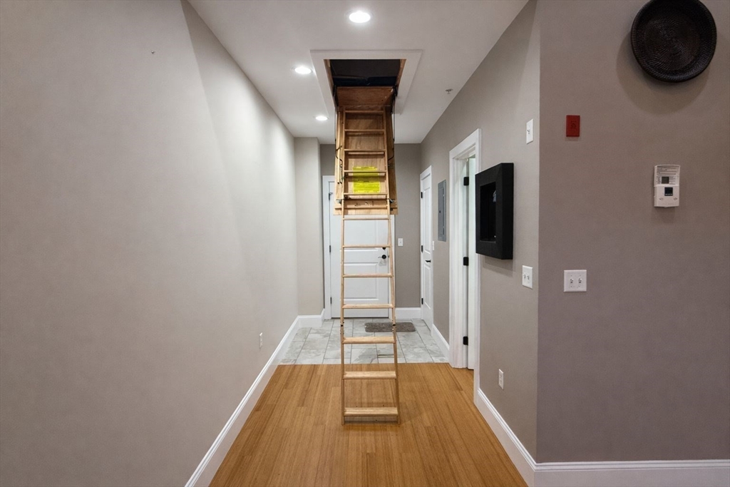 30 Market Street, Unit 7 Lowell, MA 01852 - Photo 8 of 11 a view of a hallway with wooden floor and closet