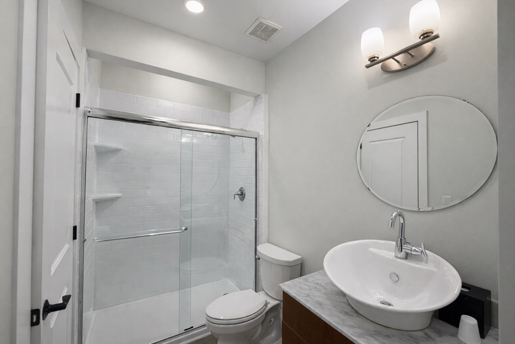 30 Market Street, Unit 7 Lowell, MA 01852 - Photo 9 of 11 a bathroom with a sink toilet and shower