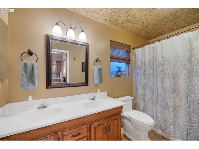 a kitchen with a sink a stove top oven and cabinets