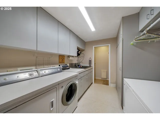 a bathroom with a toilet sink vanity and mirror