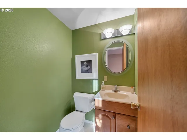 a view of a kitchen with kitchen island a window a sink and a counter top space