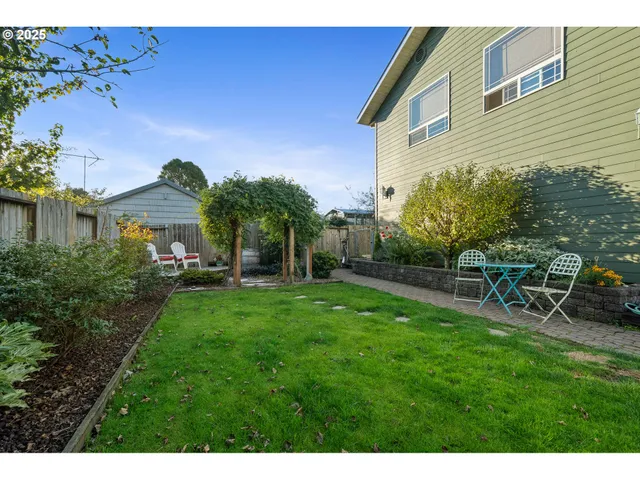 a kitchen with stainless steel appliances granite countertop a sink refrigerator and cabinets