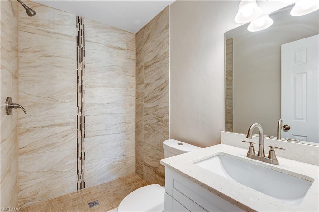 5453 16th Place Southwest Naples, FL 34116 - Photo 16 of 36 a bathroom with a sink toilet and shower