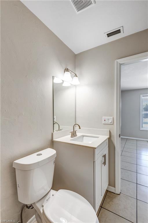 5453 16th Place Southwest Naples, FL 34116 - Photo 18 of 36 a bathroom with a sink a toilet and mirror