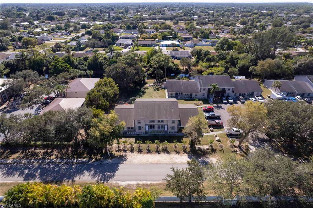 5453 16th Place Southwest Naples, FL 34116 - Photo 35 of 36 an aerial view of a house with a yard and lake view in back