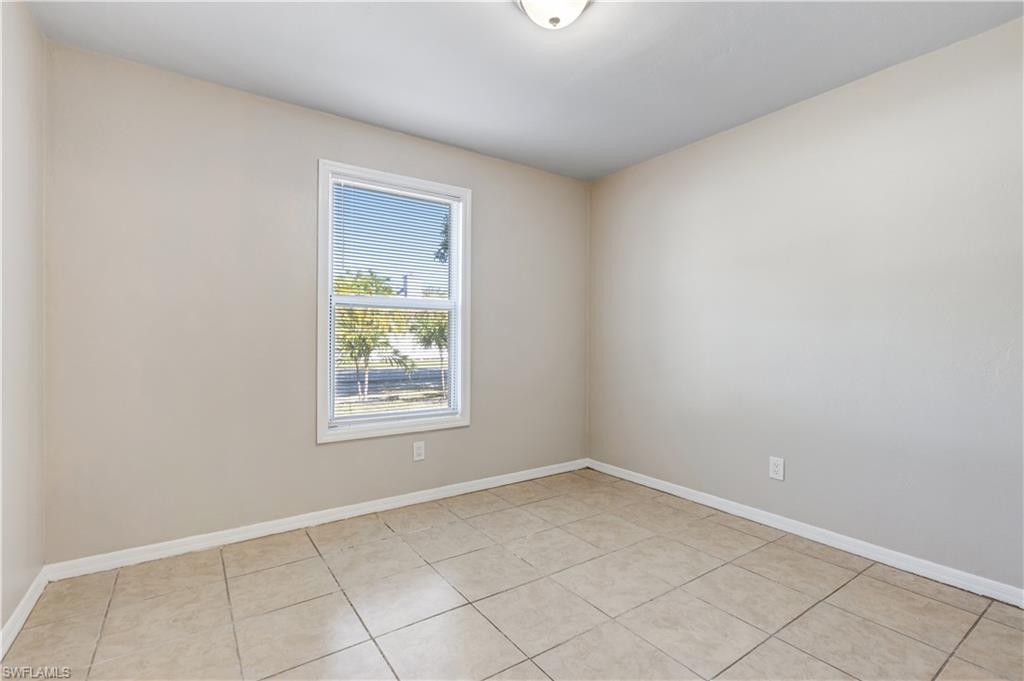 5453 16th Place Southwest Naples, FL 34116 - Photo 10 of 36 an empty room with a window