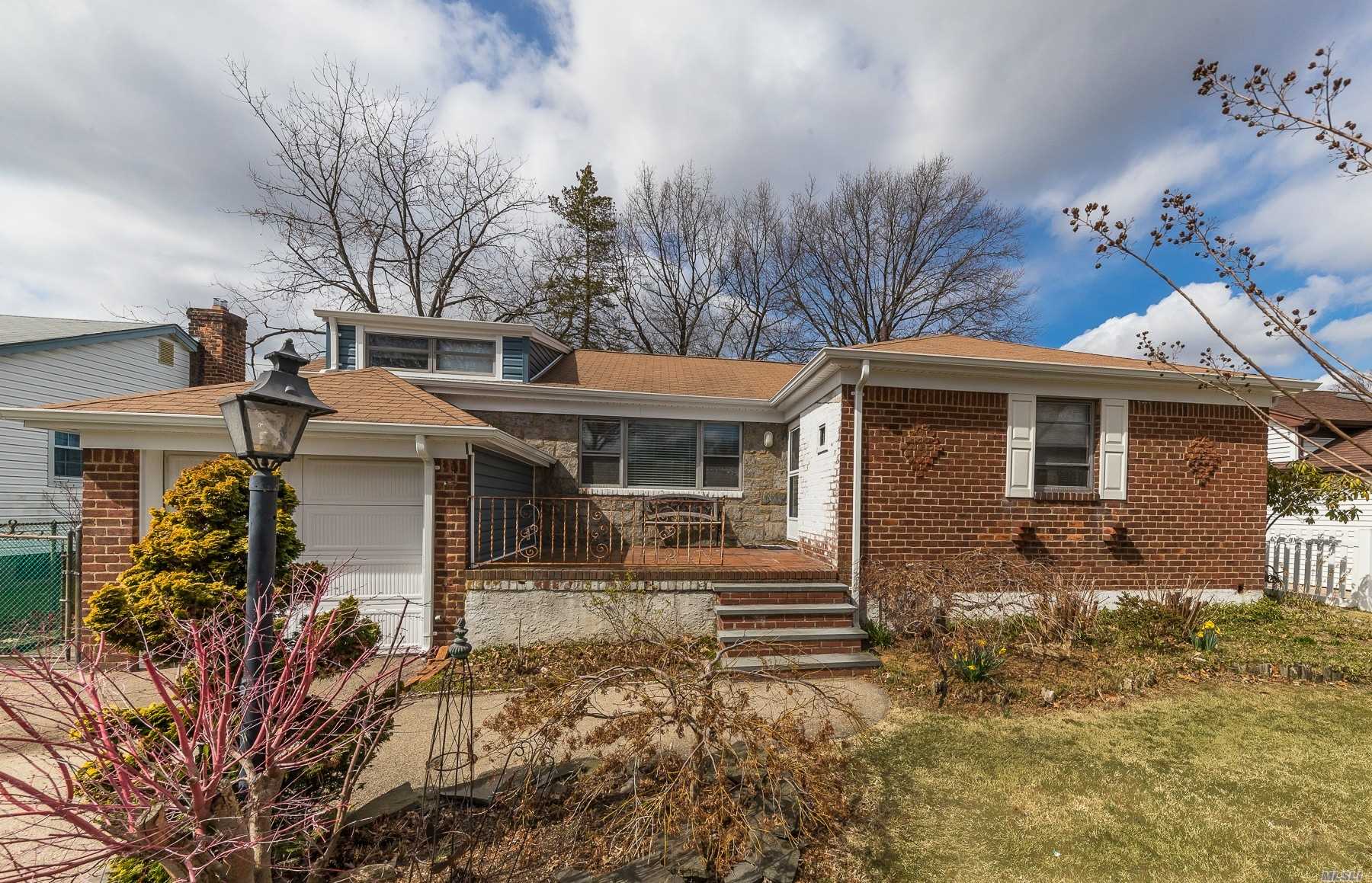 63 Wellsboro Road Valley Stream, NY 11580 - Photo 1 of 1 front view of a house with a yard