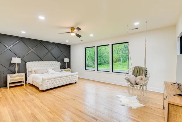 a bedroom with furniture and flat screen tv