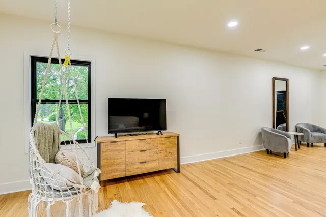 a bedroom with a bed and a large window