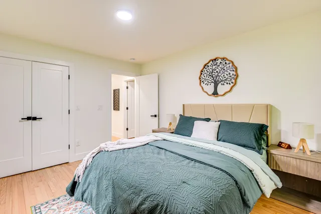 a bedroom with a bed and a flat screen tv