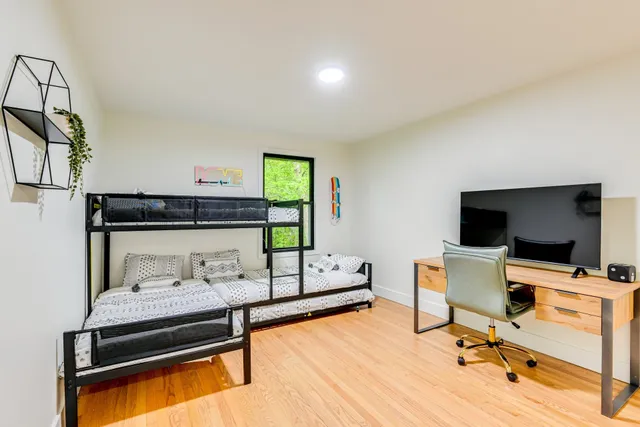 a bedroom with a bed and a window