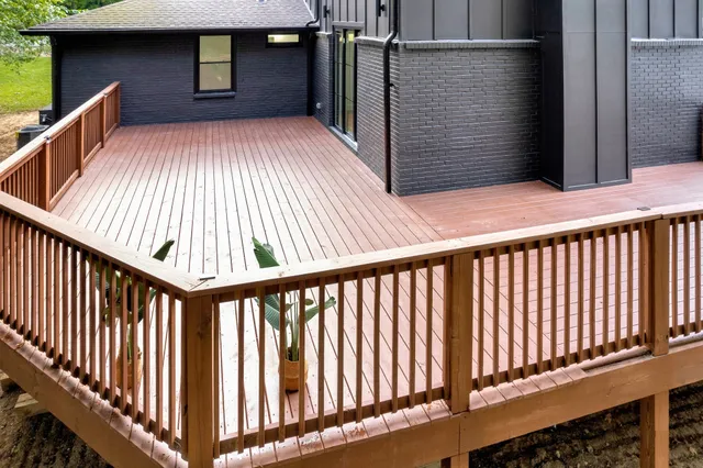 a view of a back door of the house with a chair and table