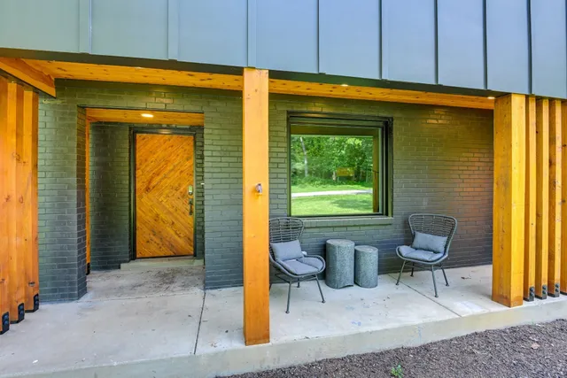 a view of backyard with a barn and a large tree