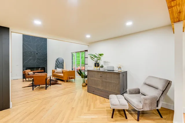 a living room with furniture a rug and a window