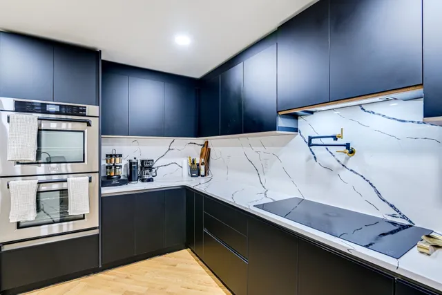 a kitchen with a sink and a stove top oven