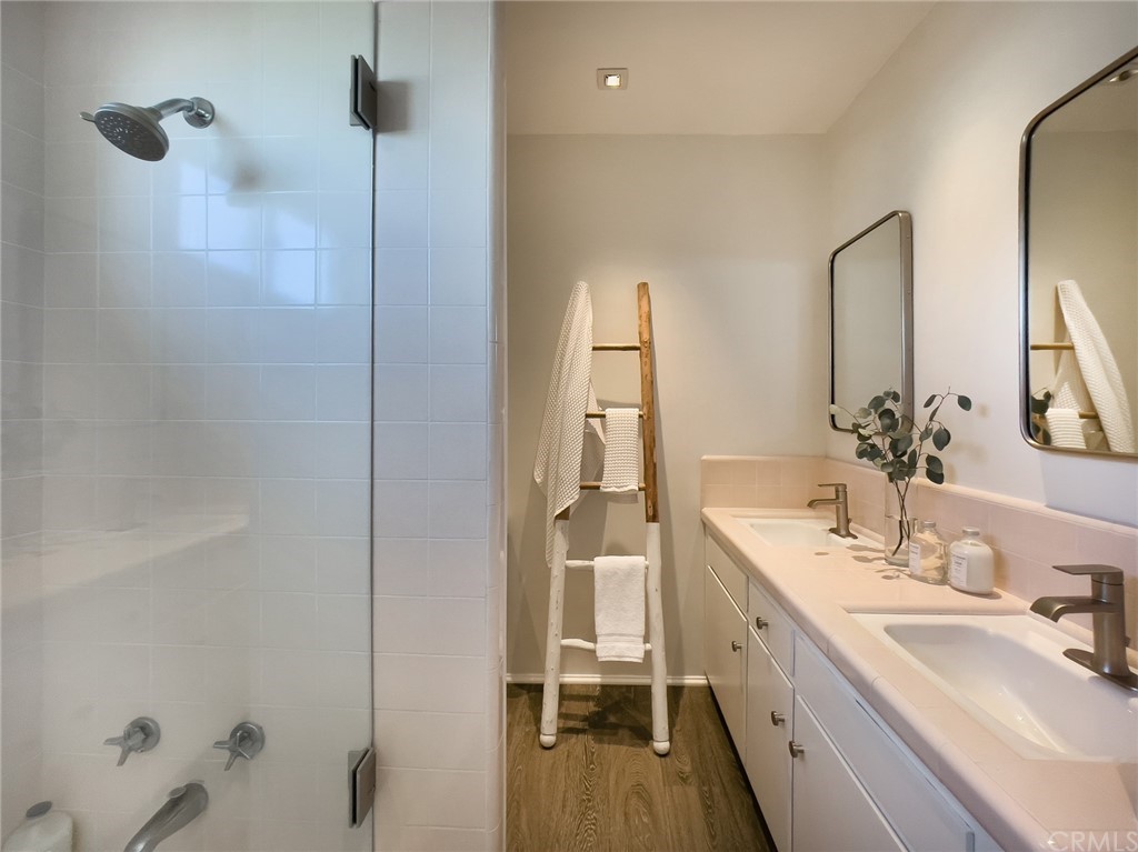 35581 Beach Road Dana Point, CA 92624 - Photo 18 of 23 a bathroom with a double vanity sink a mirror and a shower