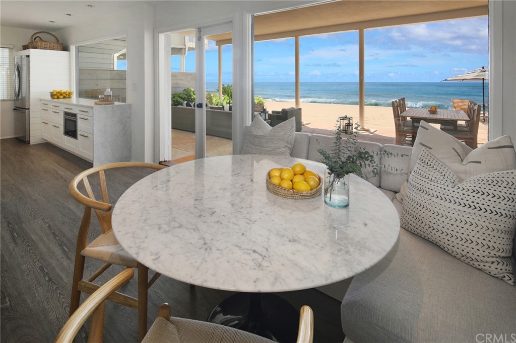 35581 Beach Road Dana Point, CA 92624 - Photo 5 of 23 a view of a dining room with furniture large windows and wooden floor